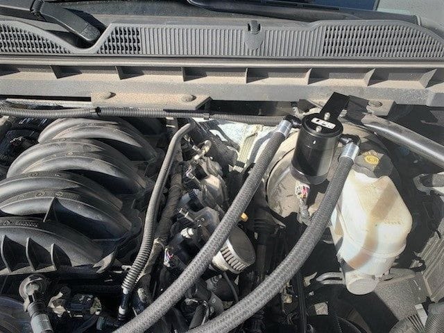 UPR Chevy Oil Catch Can Installed Oil catch can installed with braided lines on a Chevy V8 engine bay.